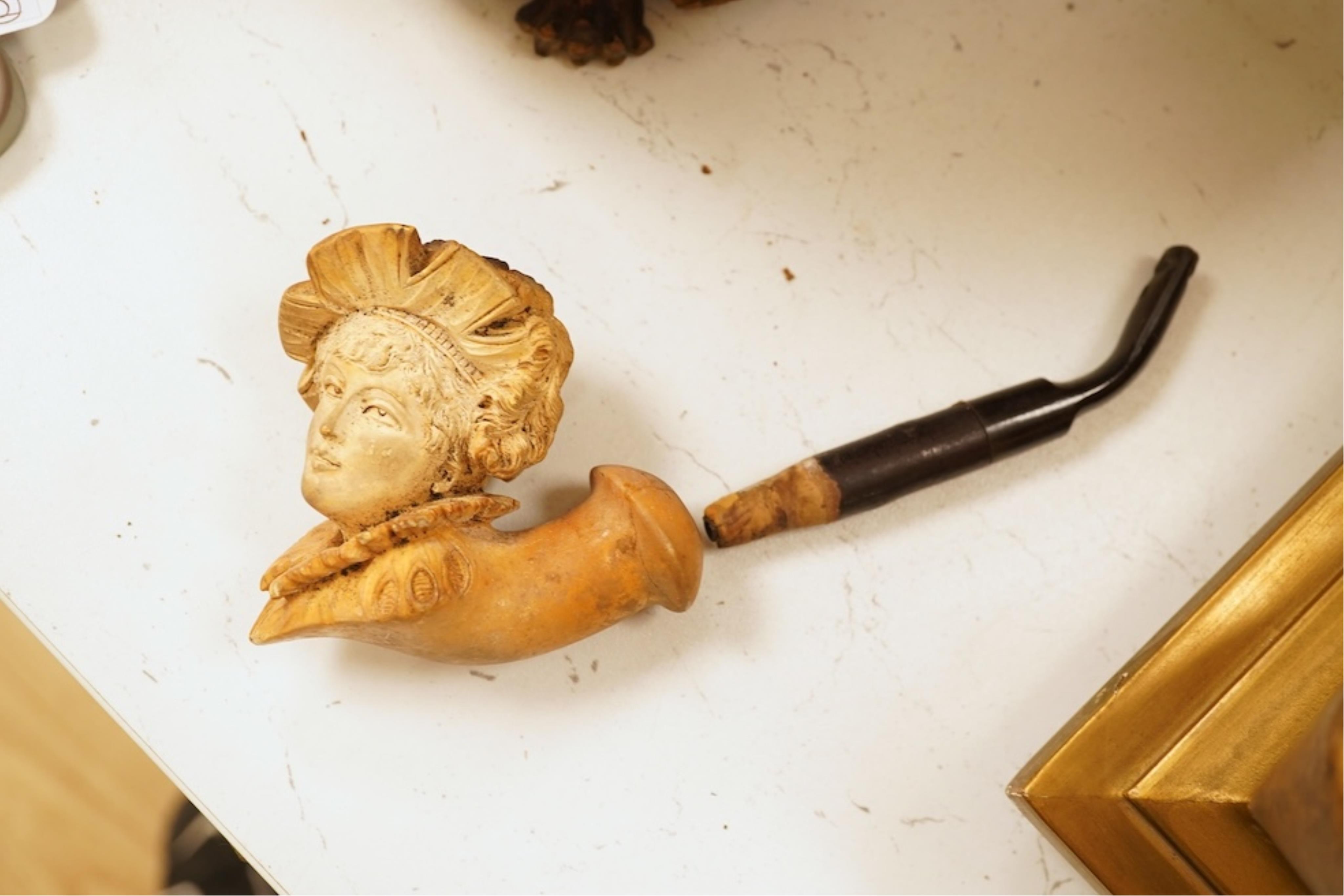 A 19th century German cold-painted terracotta bust, on ebonised socle and a Meerschaum pipe in case, bust 27cm high